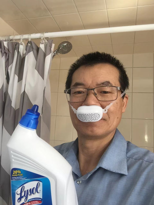 Wearing nose mask to clean the toilet at home